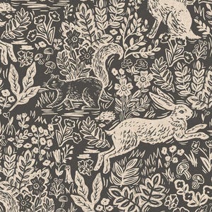 May include: A repeating pattern featuring a forest scene with squirrels, rabbits, flowers, and foliage in a cream colour on a dark grey background. The design has a hand-drawn, linocut style.