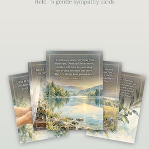 May include: Five printable sympathy cards featuring landscape illustrations and scripture text. The cards display scenes of lakes, mountains, and olive branches with gold-toned borders. Text includes Revelation 21:4 and other verses.