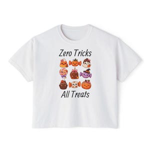 May include: A white short-sleeved t-shirt featuring the text Zero Tricks All Treats in black font. Between the lines of text is a grid of nine colorful, cute cartoon illustrations of Halloween-themed candy, sweets, and a pumpkin.