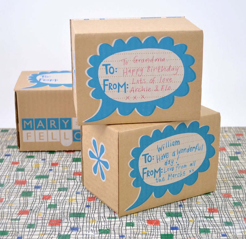 May include: Two brown cardboard gift boxes with blue speech bubbles. The top box has the text "To: Grandma. Happy Birthday. From: Lots of love. Archie & Flo." The bottom box has the text "To: William. Have a wonderful day! From: Love from all the Marahs xx."