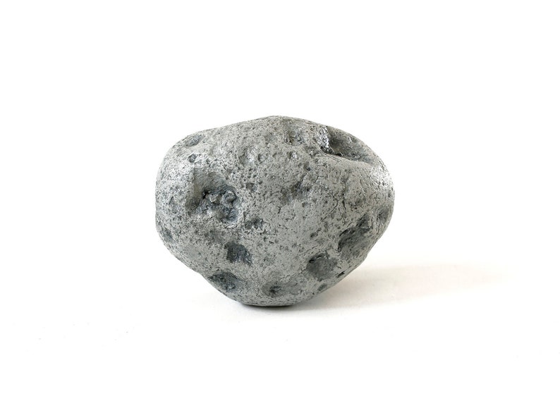 May include: A single, gray, irregularly shaped rock with a rough, textured surface.