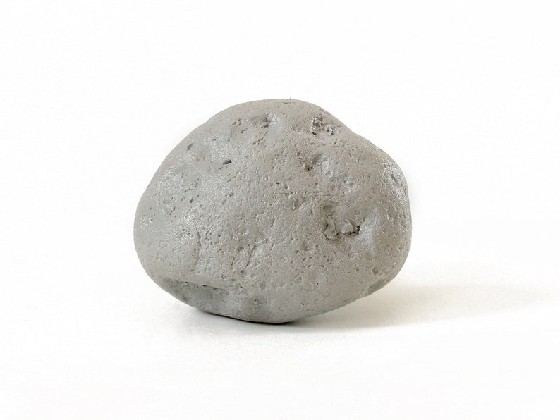 May include: A smooth, gray, rounded stone with a slightly irregular shape.