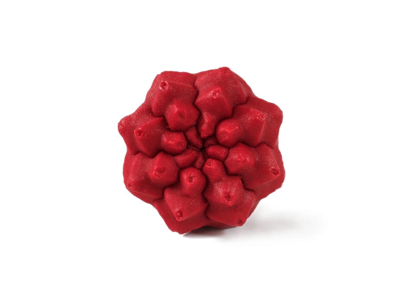 May include: A bright red, multi-faceted geometric object with a complex, repeating star-like pattern. The surface features a textured, granular finish with numerous pointed protrusions radiating from the center in a symmetrical, radial arrangement.