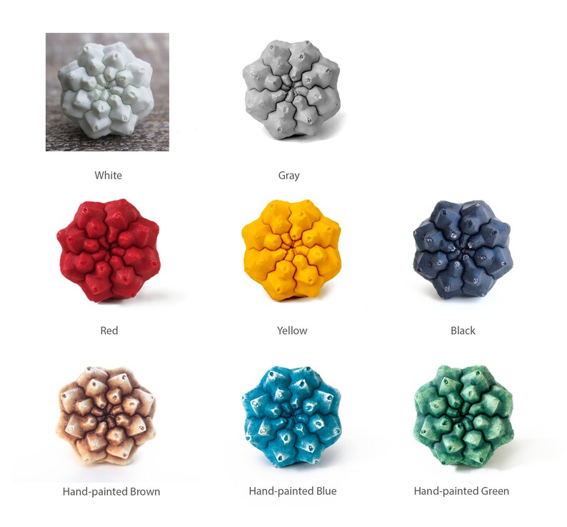 May include: A set of nine ceramic flower-shaped ornaments in various colors, including white, gray, red, yellow, black, brown, blue, and green. The ornaments are all the same shape and size, and they are arranged in a grid pattern.