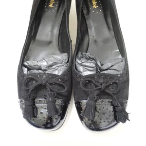 May include: Pair of black suede and patent leather heeled shoes with a bow and tassel detail. The shoes are labelled "Chloé" on the inside.