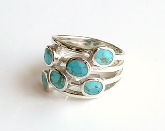 Beautiful natural blue chrysocolla stones cluster on sterling silver bezel set ring.