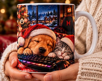 May include: A white ceramic mug featuring a graphic of a golden retriever puppy and a tabby kitten wearing Santa hats, sleeping on a backlit gaming keyboard. The background shows a snowy winter scene with a decorated Christmas tree.
