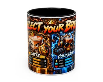 May include: A black-rimmed ceramic mug featuring a vibrant graphic with the text SELECT YOUR BREW. The design displays two characters: a latte with a shield and a cold brew with headphones, each accompanied by game-style stat bars.