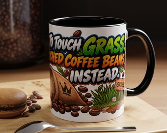 May include: A white ceramic mug with a black handle and interior, featuring a graphic of a burlap sack spilling coffee beans, green grass, and the text "TO TOUCH GRASS, TOUCH COFFEE BEANS INSTEAD." The design includes a small crown icon.