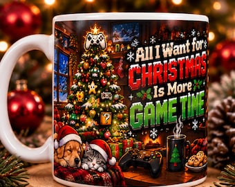 May include: A white ceramic mug featuring a Christmas tree decorated with gaming controllers, a sleeping dog and cat wearing Santa hats, a game controller, and the text All I Want for CHRISTMAS Is More GAME TIME.