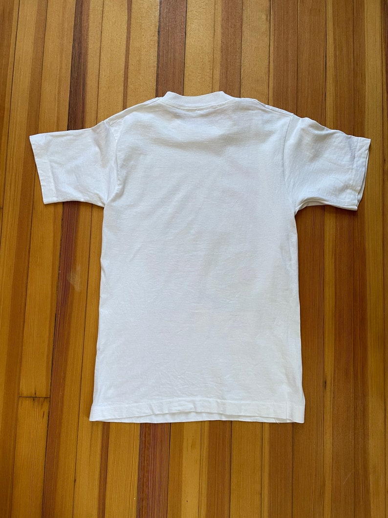 May include: A white short-sleeved t-shirt with a crew neck.