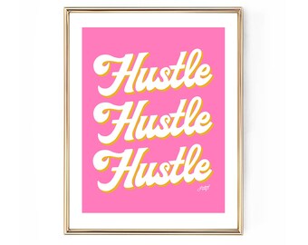 May include: A framed print with a gold-colored frame. The artwork features the word "Hustle" repeated three times in a white, retro-style font with a yellow outline, set against a bright pink background. The artist's signature is in the bottom right corner.