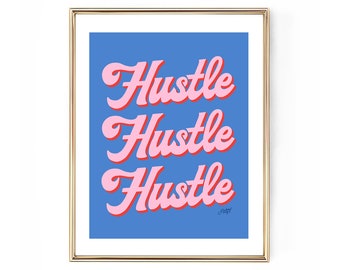 May include: A framed art print with the word "Hustle" repeated three times in a pink, retro font with a red outline, set against a blue background. The print is in a gold frame.