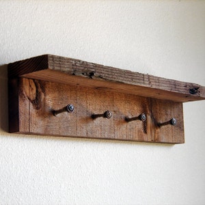 May include: Rustic wooden shelf with five metal hooks, perfect for hanging keys, coats, or other items.