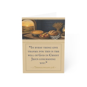 May include: A greeting card featuring a harvest scene with a pie, bread, and apples on a table. Below the image, the text reads: "In every thing give thanks: for this is the will of God in Christ Jesus concerning you." - 1 Thessalonians 5:18 -