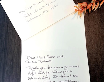 May include: A white folded thank you card with black handwritten ink. The front envelope is addressed to Mr. & Mrs. Robert Whitmore, 1245 Willow Lane, Columbus, OH 43215. The inside reads: Dear Aunt Susan and Uncle Robert: Thank you for your generous gift.