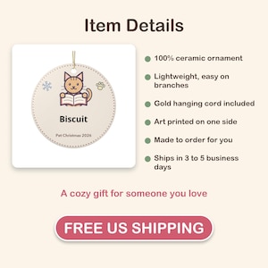May include: A round ceramic ornament featuring a cartoon cat reading a book with the text Biscuit and Pet Christmas 2026. The ornament has a gold hanging cord and is decorated with a small snowflake and a paw print icon on a light background.