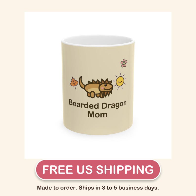 May include: A beige ceramic mug featuring a cartoon illustration of a brown bearded dragon, a small orange leaf, a yellow sun, and a pink flower. The text "Bearded Dragon Mom" is printed in dark brown letters below the lizard graphic.