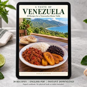 May include: A digital tablet displaying a cookbook cover titled A TASTE OF VENEZUELA 30 Recipes for a Venezuelan Home Table. The cover features a plate of shredded beef, rice, black beans, and fried plantains with a coastal mountain view.