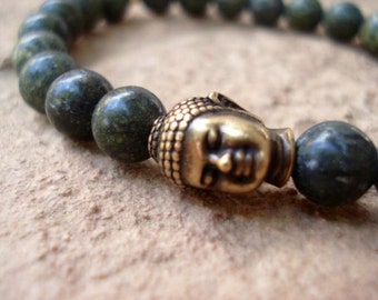 May include: A green stone beaded bracelet with a gold Buddha head charm.