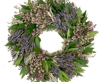 May include: A dried lavender and bay leaf wreath with a natural, rustic look. The wreath is made with a variety of dried herbs and flowers, including lavender, bay leaves, and sage. The wreath is perfect for adding a touch of natural beauty to your home.