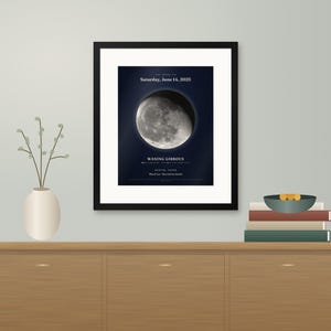 May include: A framed wall print featuring a detailed image of the moon in a waning gibbous phase. The text reads: The moon on Saturday, June 14, 2025, Waning Gibbous, Austin, Texas, Mia & Leo - Married in Austin.
