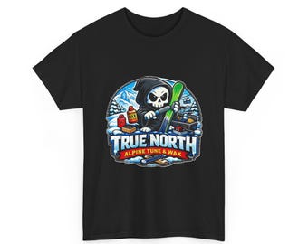 May include: A black t-shirt featuring a graphic of a hooded skeleton tuning a green ski. The text reads TRUE NORTH ALPINE TUNE & WAX. The background shows a snowy mountain landscape with ski equipment, including wax bottles and tools.