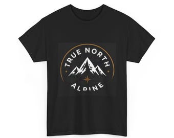 May include: A black short-sleeve t-shirt featuring a circular graphic on the chest. The design includes white mountain peaks, a gold compass star, and the text "TRUE NORTH" above and "ALDINE" below the mountain illustration.