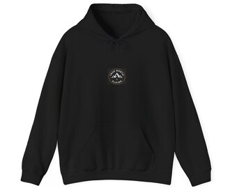 May include: A black hooded sweatshirt featuring a central circular logo on the chest. The logo contains a white mountain graphic and the text True North Alpine. The garment includes a front kangaroo pocket, long sleeves, and a drawstring hood.
