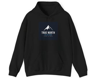 May include: A black hooded sweatshirt featuring a dark blue square graphic on the chest. The graphic displays a white mountain peak icon above the text TRUE NORTH, ALPINE, and TUNE & WAX in white and light blue lettering.