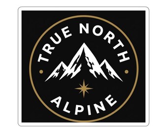 May include: A square sticker featuring a black background with a gold circular border. Inside the circle, white text reads TRUE NORTH ALPINE. A white mountain graphic sits above a gold four-pointed star centered at the bottom.