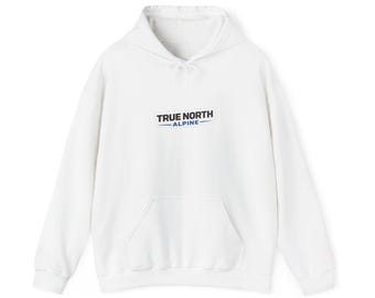 May include: A white hooded sweatshirt featuring a front kangaroo pocket and long sleeves. The chest displays the text TRUE NORTH ALPINE in black and blue lettering, centered within a rectangular graphic design on the fabric.