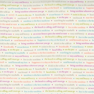 May include: A cream-coloured fabric featuring a repeating pattern of beach-themed phrases in various colours, including "the beach is calling, and I must go," "sunshine is the best medicine," "sand beneath my feet," and "an ocean breeze puts the mind at ease."