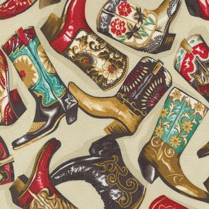 May include: A beige fabric with a repeating pattern of colorful cowboy boots. The boots are decorated with floral designs and have a variety of colors, including red, blue, green, yellow, and brown.