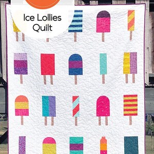 May include: A quilt pattern featuring a colorful ice lolly design. The quilt is made up of ten unique 12" x 18" blocks. The pattern is available in seven sizes: Baby through King.  The quilt is shown hanging on a wooden fence.