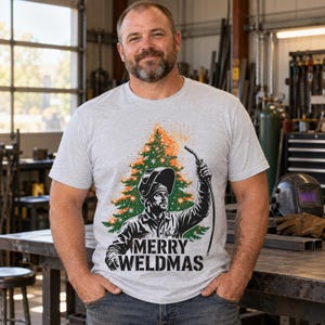 Merry Weldmas Christmas shirt — worn by model