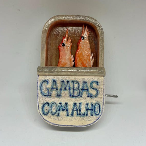 A hand-cranked wooden automaton themed around tinned seafood — oddly specific, deeply funny, and undeniably clever for $40.