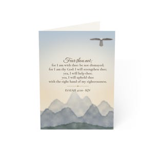 May include: A greeting card featuring a watercolour mountain landscape at dawn with a flying bird silhouette. The text reads: Fear thou not; for I am with thee: be not dismayed; for I am thy God: I will strengthen thee; Isaiah 41:10 KJV.