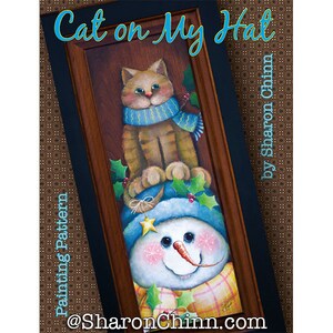 May include: Painting pattern for a snowman with a cat sitting on its hat. The snowman is wearing a blue hat with a star and a plaid scarf. The cat is wearing a blue scarf. The painting is titled "Cat on My Hat" by Sharon Chinn.