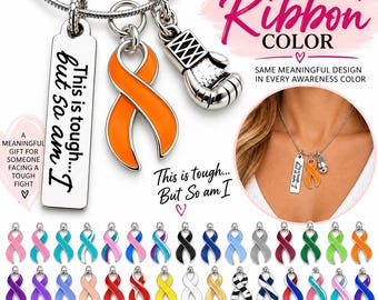 May include: A silver-toned necklace featuring three charms: a rectangular pendant engraved with the text 'This is tough... but so am I', an orange awareness ribbon, and a boxing glove. The set includes various colored ribbon charm options.