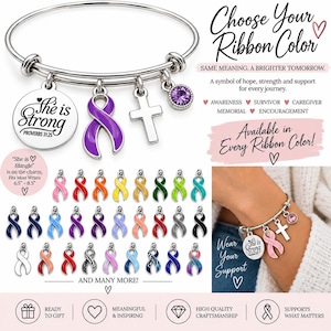 May include: A silver-tone bangle bracelet featuring four charms: a round disc engraved with "She is Strong PROVERBS 31:25", a purple awareness ribbon, a plain cross, and a small purple crystal. The set includes various colored ribbon charms.
