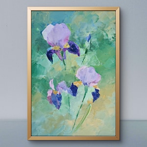 May include: An oil painting of three purple and blue iris flowers with yellow accents, rendered with thick, visible brushstrokes. The floral subject is set against a textured, abstract background of light green and yellow tones, enclosed in a thin gold frame.