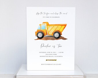 May include: A yellow and orange construction truck with a black tire and a brown dirt background. The text "stop the traffic and close the road" is at the top of the invitation. The text "Parker is two" is in the center of the invitation. The text "Saturday, June 26, 2021 | 1:00 PM" is below the truck. The text "Polliwog Park" is below the date. The text "Manhattan Beach, California" is below the park name. The text "RSVP to Mom at 310.123.4567" is at the bottom of the invitation.