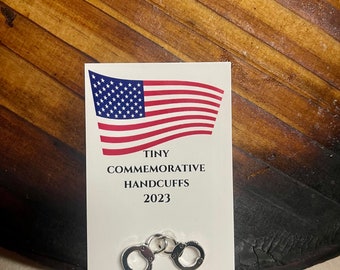 Tiny commemorative handcuffs indictment 2023