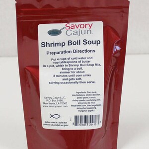 May include: Red pouch with a white label that reads "Savory Cajun Shrimp Boil Soup". The label includes preparation directions and a list of ingredients. The pouch has a fish symbol and a barcode.