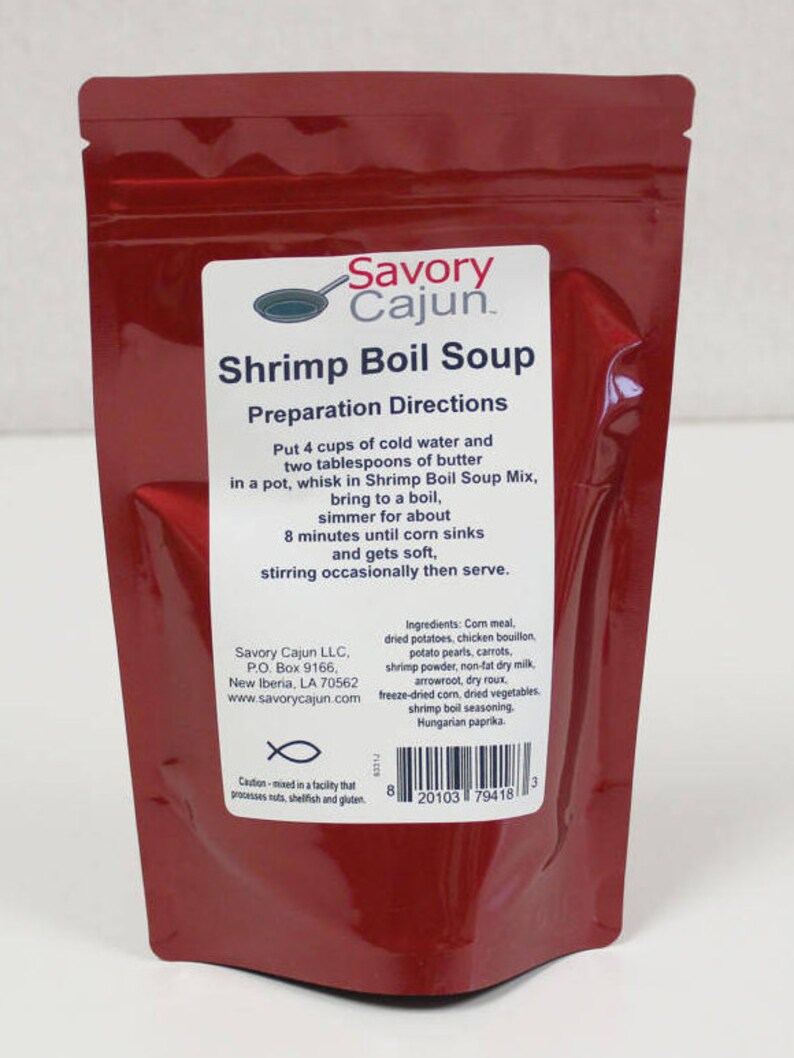 May include: Red pouch with a white label that reads "Savory Cajun Shrimp Boil Soup". The label includes preparation directions and a list of ingredients. The pouch has a fish symbol and a barcode.