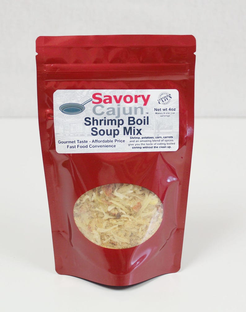 May include: A red resealable pouch with a clear window showing a mix of spices and herbs. The pouch is labeled "Savory Cajun Shrimp Boil Soup Mix" with the text "Net wt 4oz" and "Gourmet Taste - Affordable Price Fast Food Convenience".