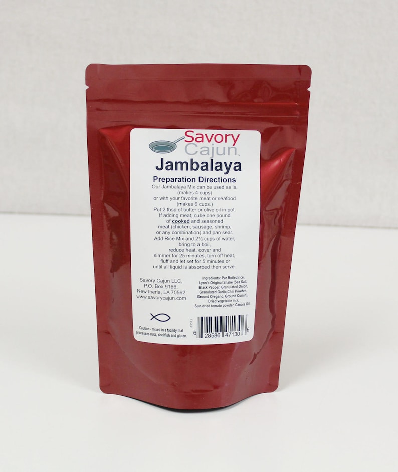 May include: A red resealable pouch with a white label that reads "Savory Cajun Jambalaya". The label includes instructions for preparing the jambalaya mix, which makes 4 cups. The label also lists the ingredients and nutritional information.