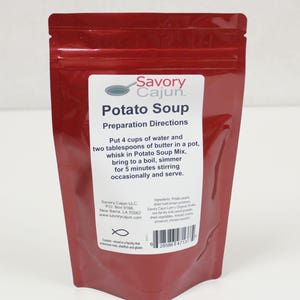 May include: A red pouch of Savory Cajun Potato Soup mix. The label includes preparation directions: add water and butter, bring to a boil, and simmer. The package also lists ingredients and contact information.