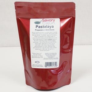 May include: Red resealable pouch with a white label that reads "Savory Cajun. Pastalaya Preparation Directions". The label includes instructions for preparing a Pastalaya dish, a list of ingredients, and a fish symbol.